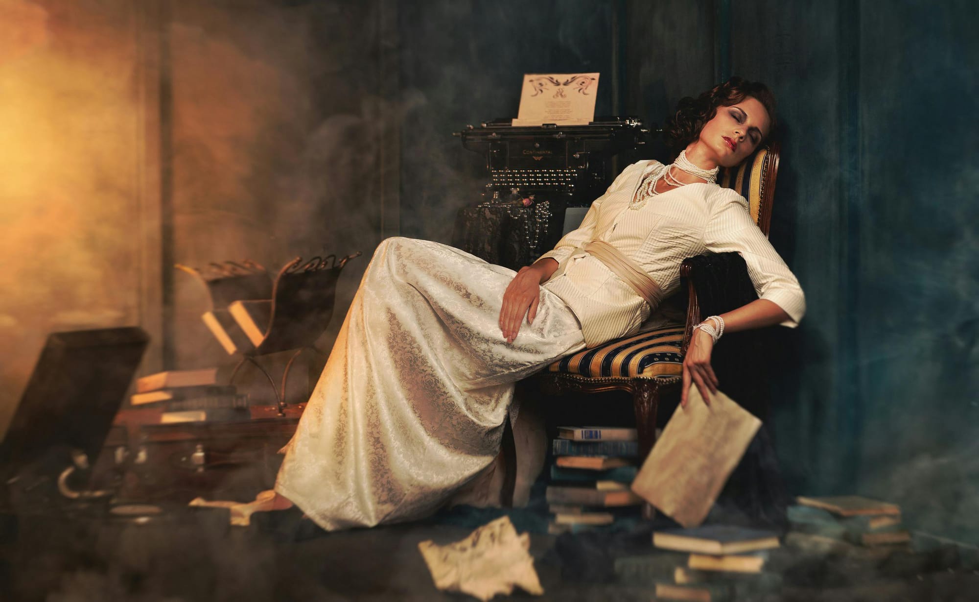 woman lying on a chair surrounded by books