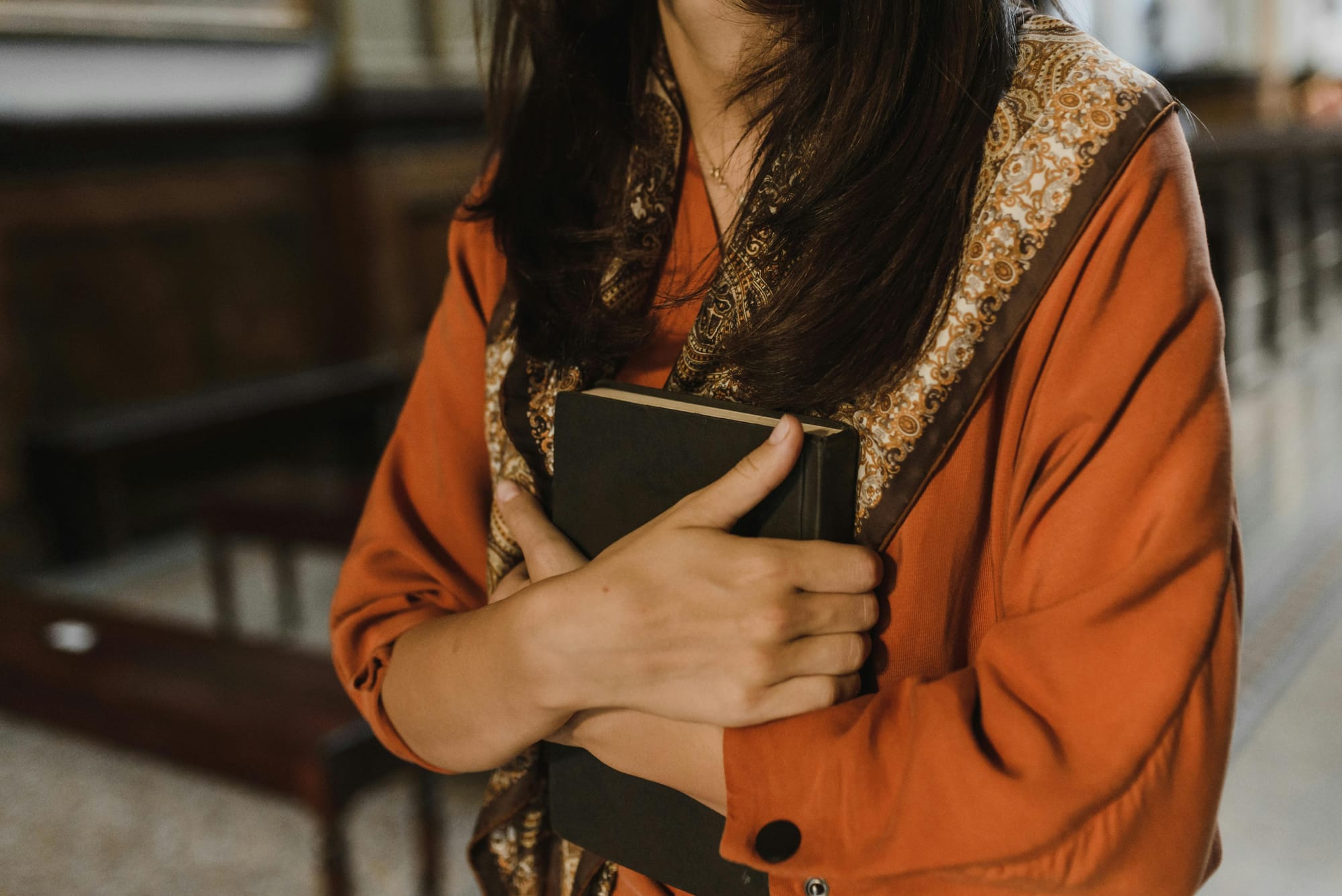 woman hugging a black book